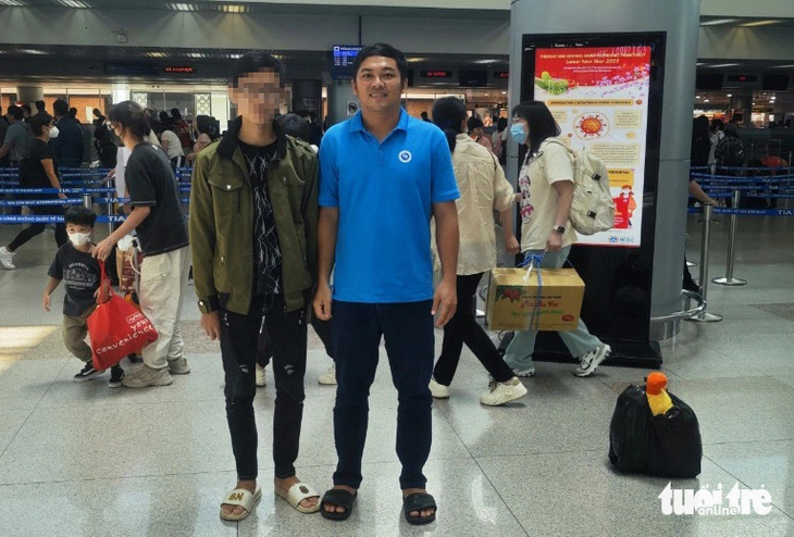 Zheng Huanyi (bên trái) và ông Minh chụp ảnh lưu niệm ở sân bay Tân Sơn Nhất, TP.HCM - Ảnh: TIẾN MINH
