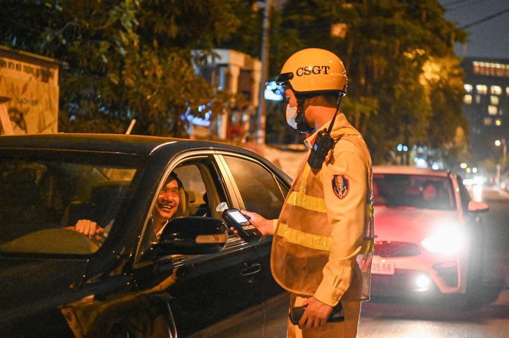 Cảnh sát kiểm tra nồng độ cồn đối với tài xế - Ảnh: HỒNG QUANG