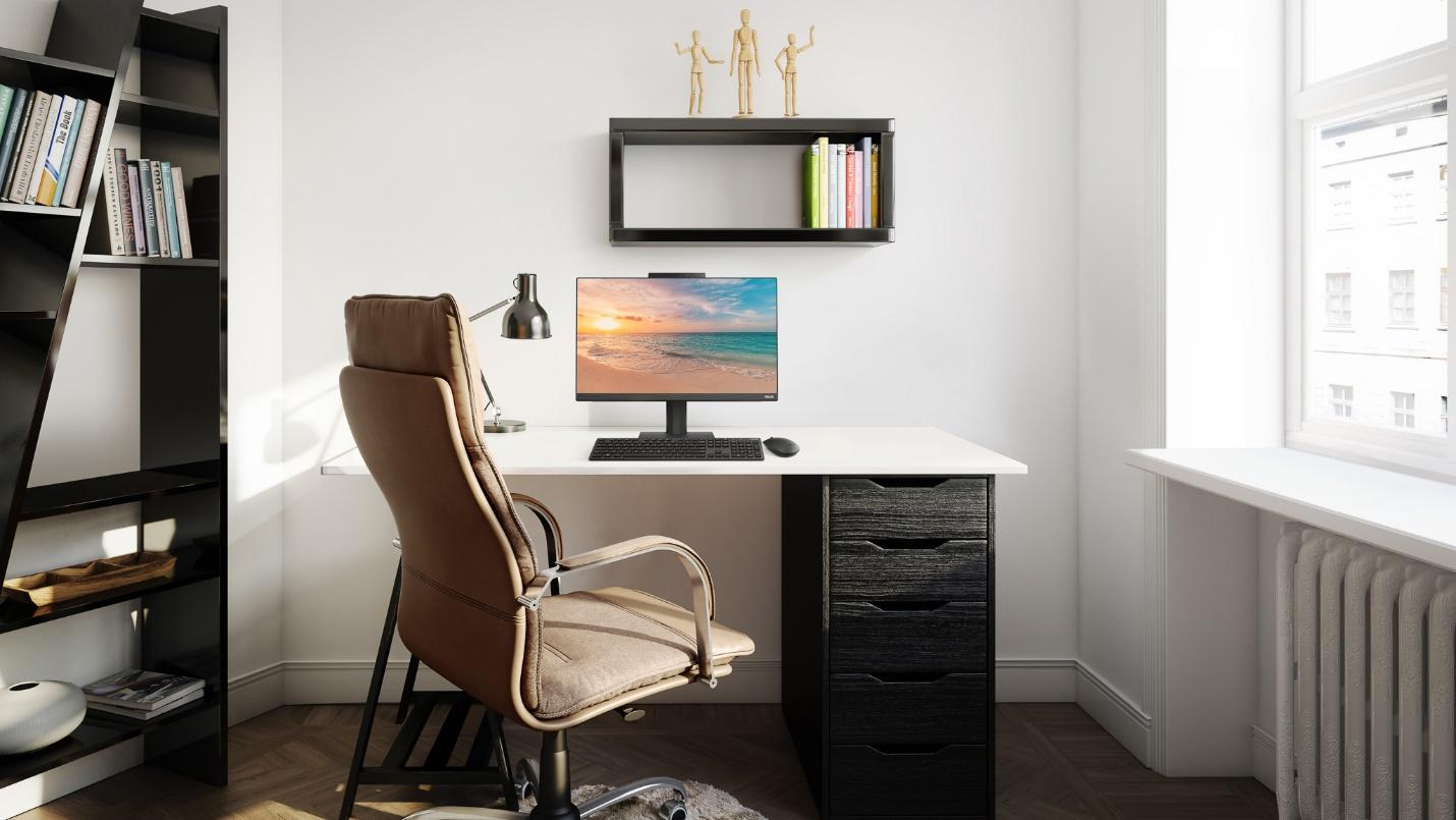 A desk with a computer and a chairDescription automatically generated