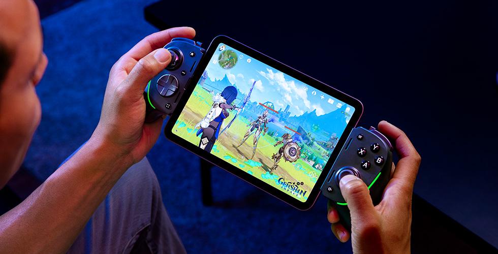 A person holding a device with a game on itDescription automatically generated